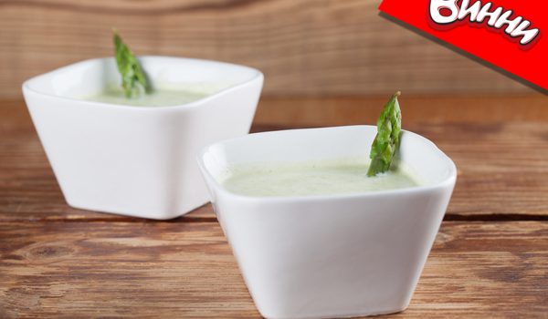 Asparagus cream soup in white bowls. Shallow dof