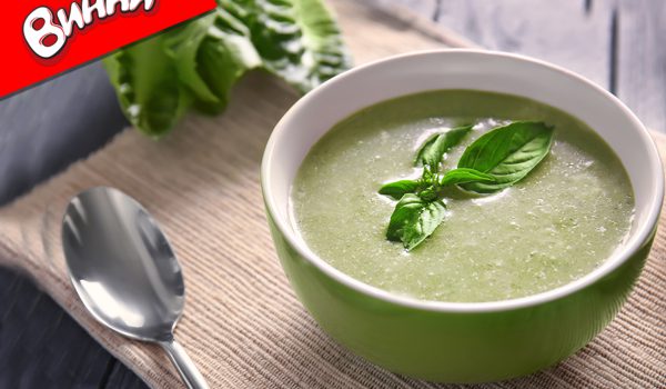 Bowl with fresh kale soup on table